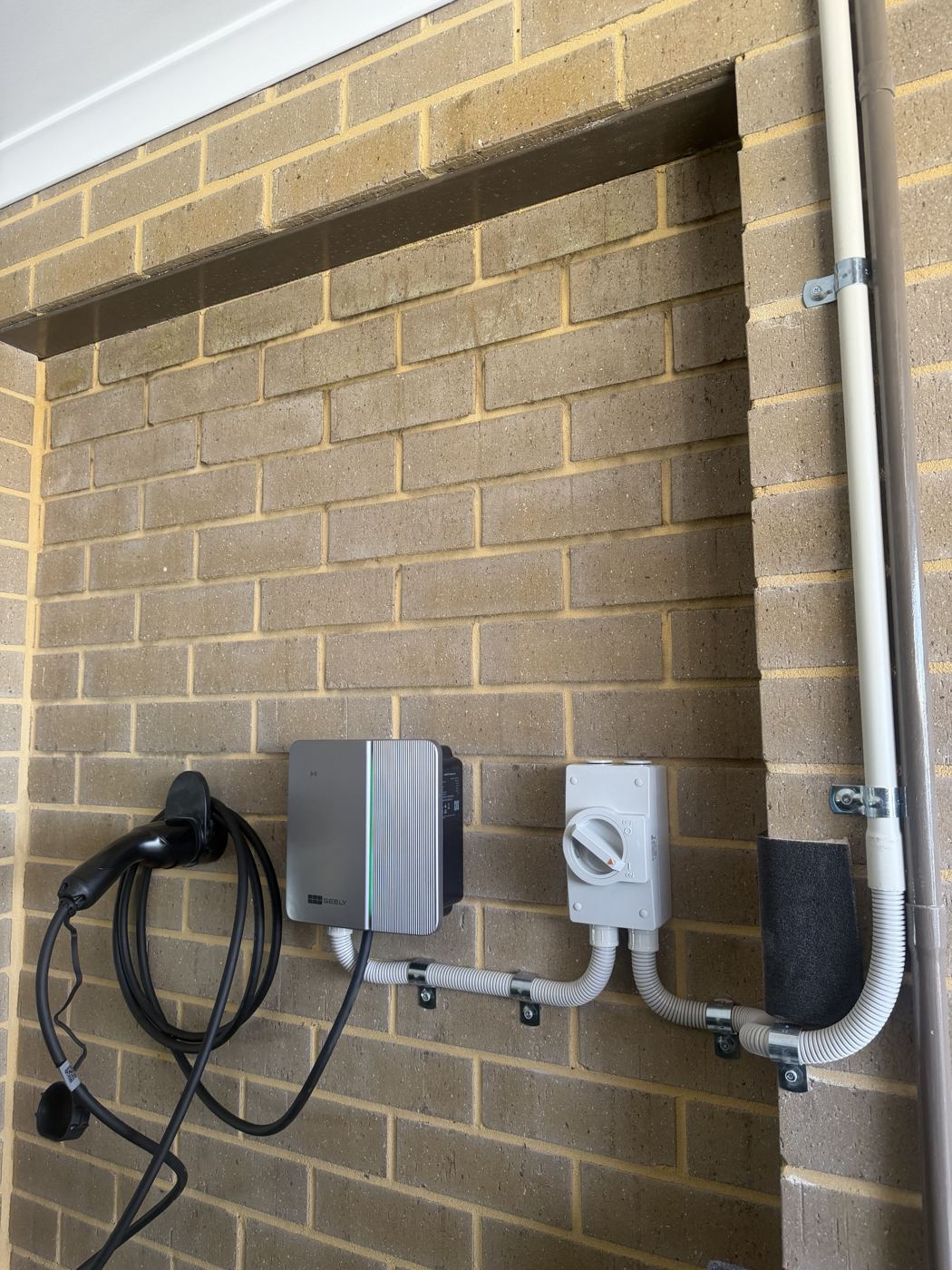 Wall-mounted EV charger with isolator and conduit