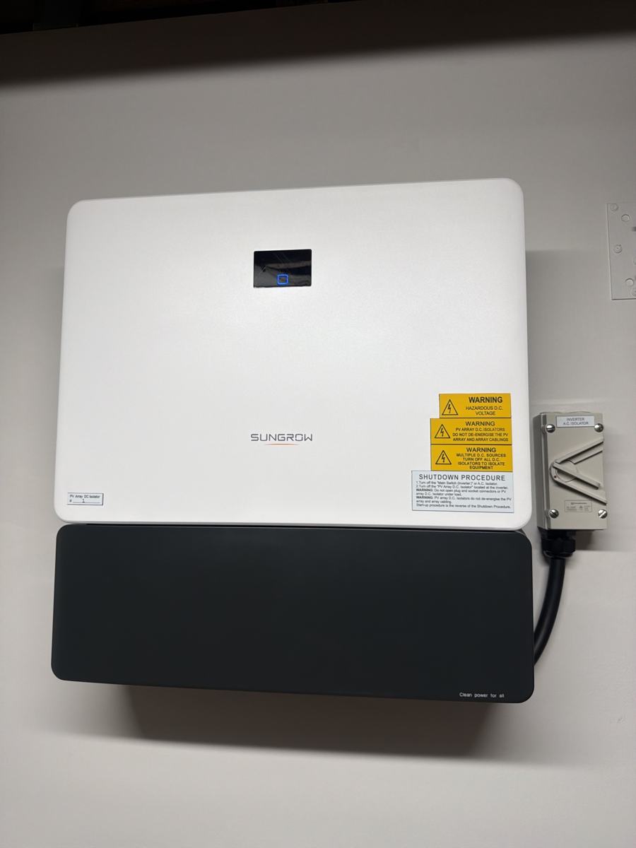 Sungrow inverter and battery mounted on a wall with isolator