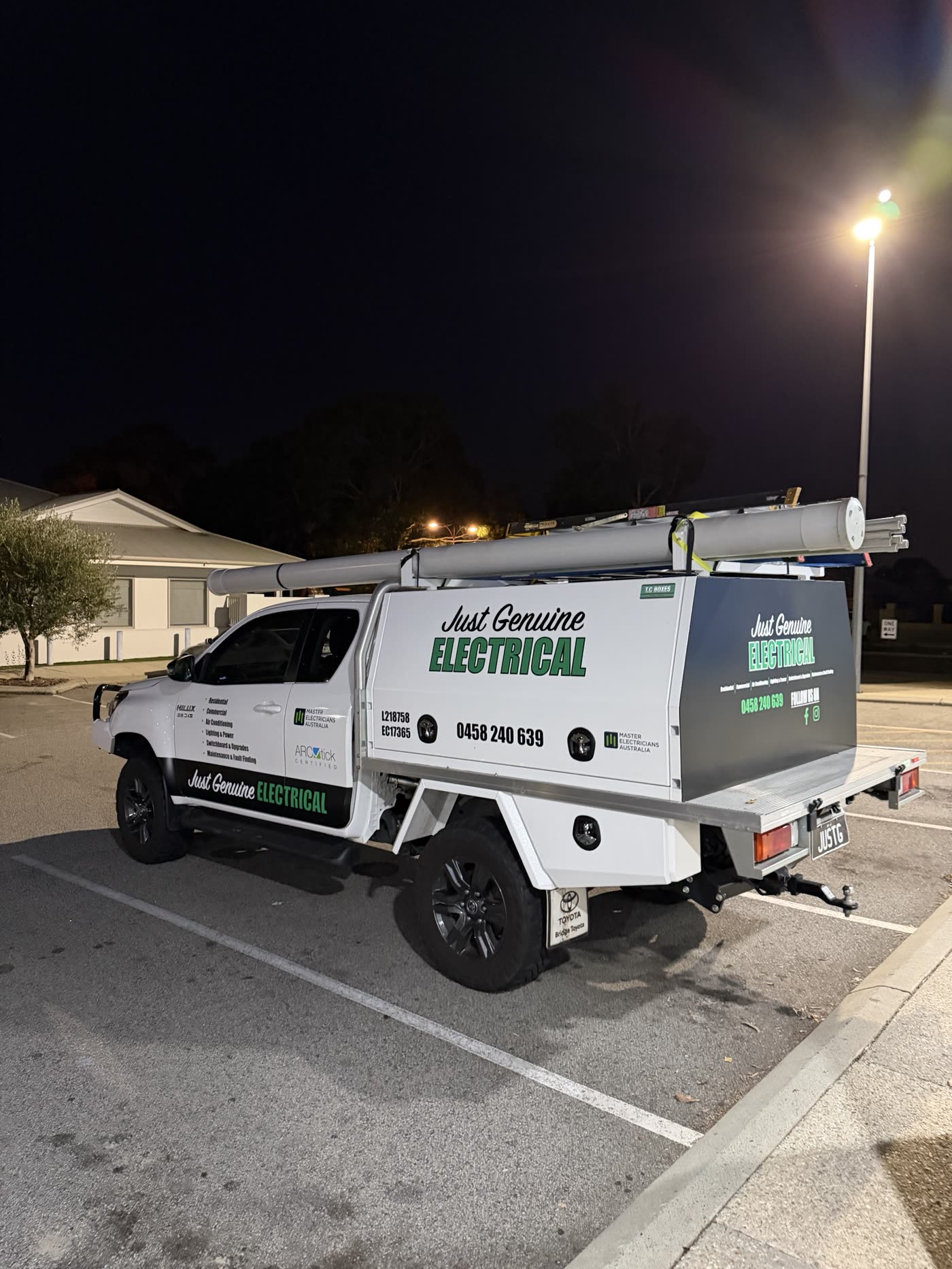 Just Genuine Electrical work ute with roof racks and conduit